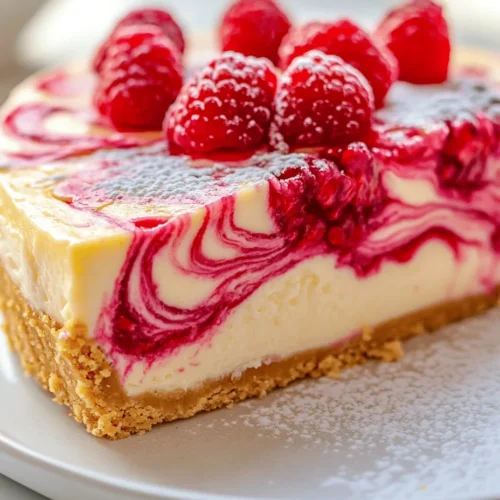 If you're searching for a dessert that perfectly balances sweet and tart flavors, look no further than the Lemon Raspberry Swirl Cheesecake. This delightful dessert not only tantalizes your taste buds but also dazzles the eye with its beautiful swirls of vibrant raspberry against a creamy lemon backdrop. The combination of creamy cheese, zesty lemon, and luscious raspberries creates a symphony of flavors that is sure to impress at any gathering.
